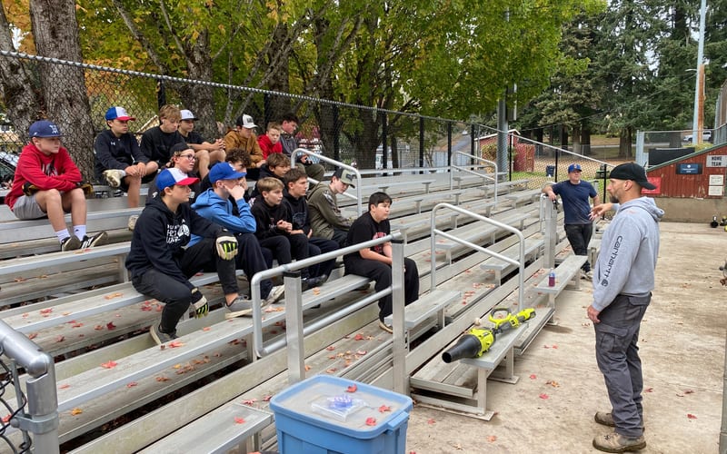 Youth baseball team with coach in dugout